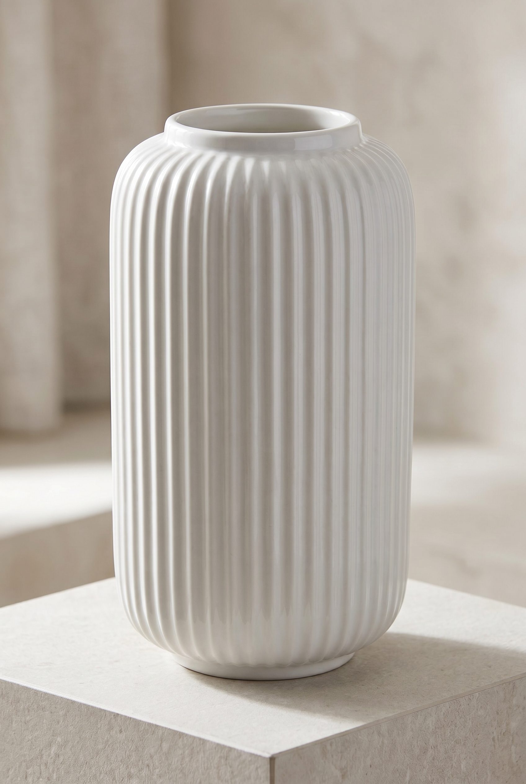 Realistic AI product image generator hero shot of a sculptural white ceramic vase