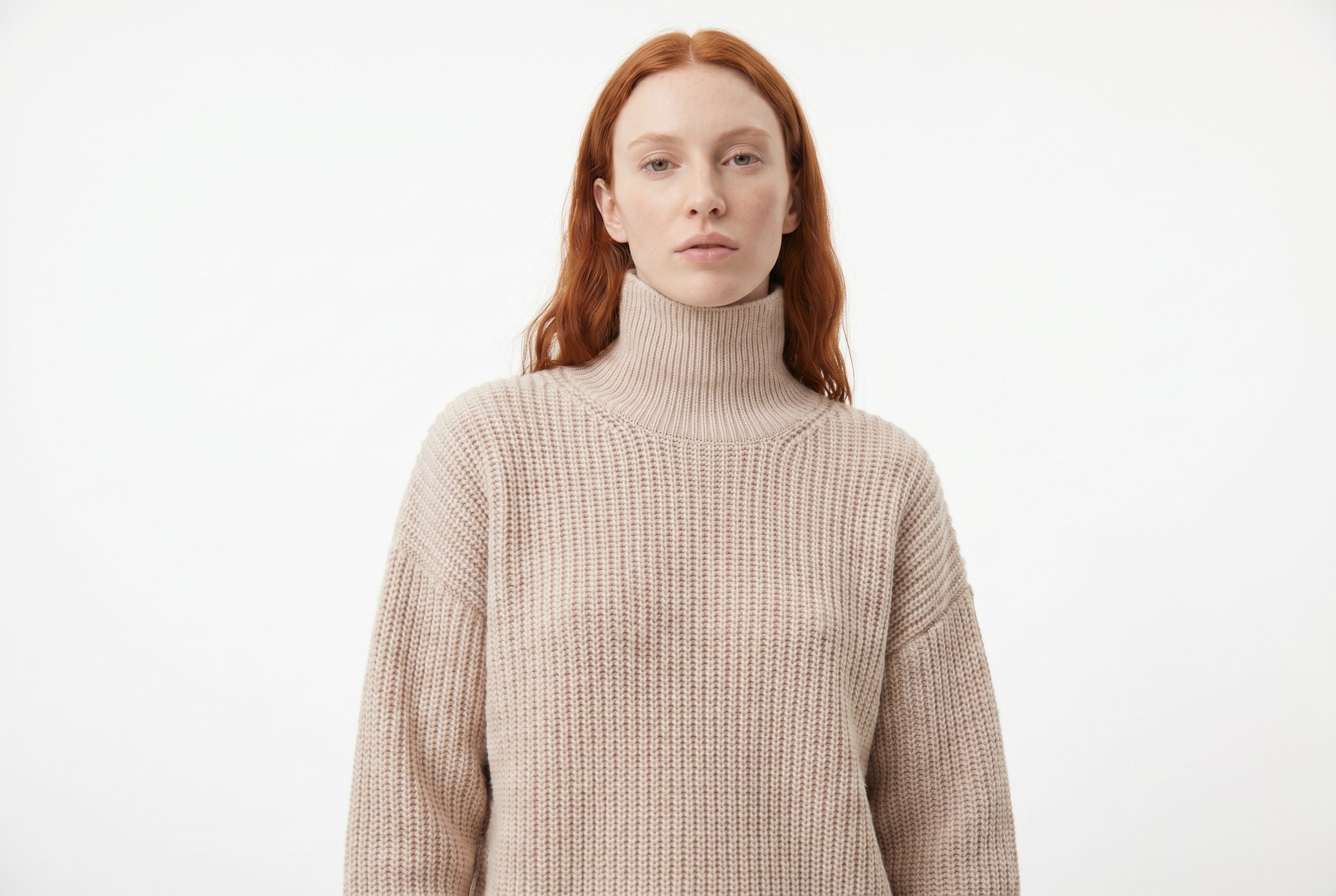 Fotogenic AI model generator output showing a red haired model wearing a beige turtleneck sweater in a clean 3 by 2 studio crop