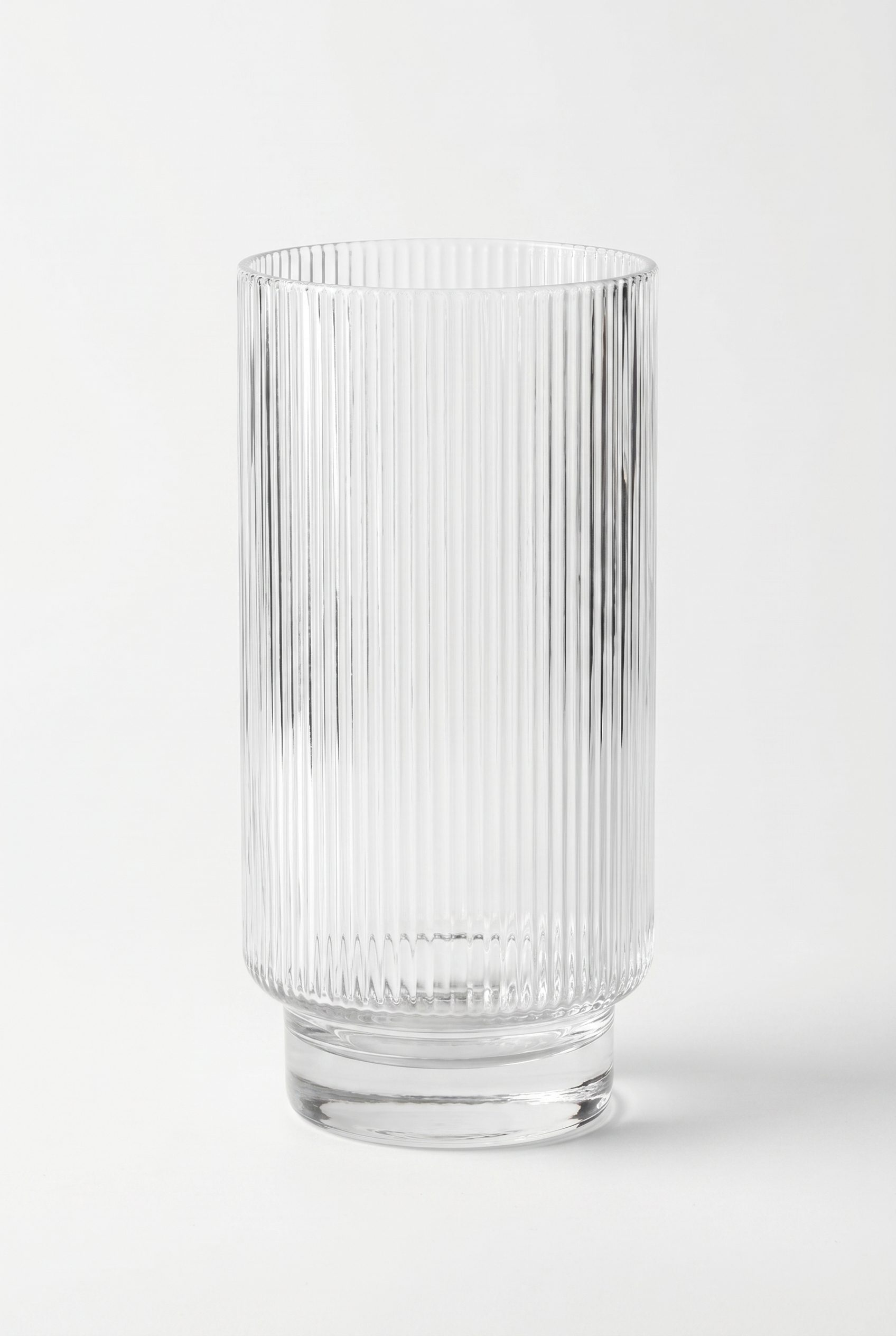 Fotogenic AI product photography hero showing a ribbed glass tumbler in a clean ecommerce studio frame