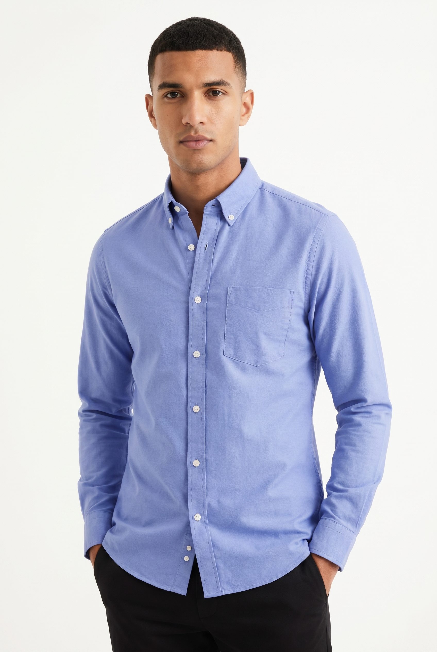 Apparel product photography example with a blue oxford shirt on a clean studio model