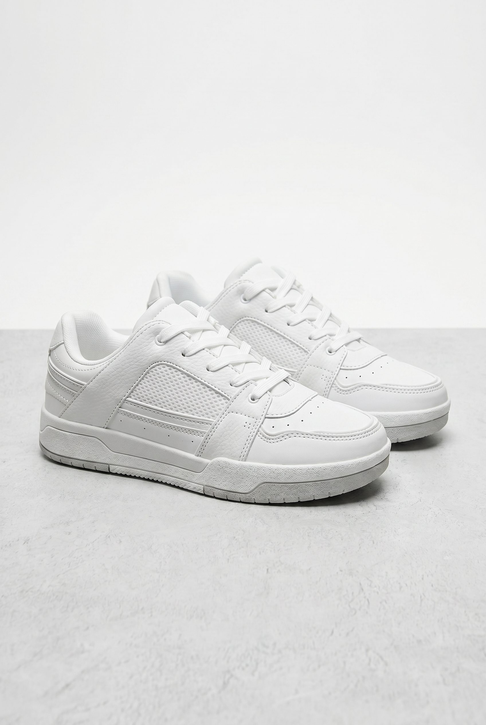Shopify product visual showing white low profile sneakers for apparel and fashion products
