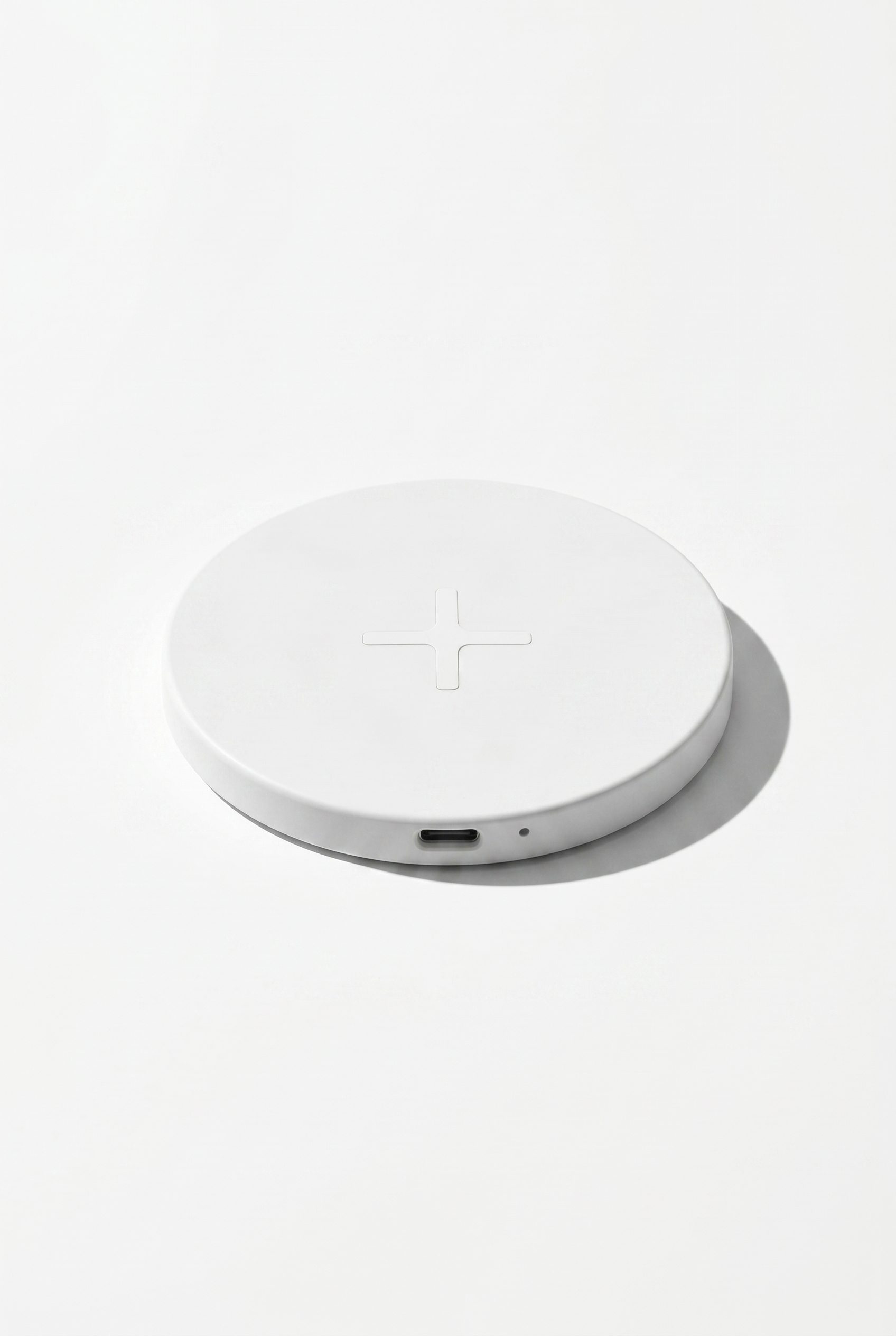 Amazon product photography style image of a white wireless charger with crisp ecommerce lighting