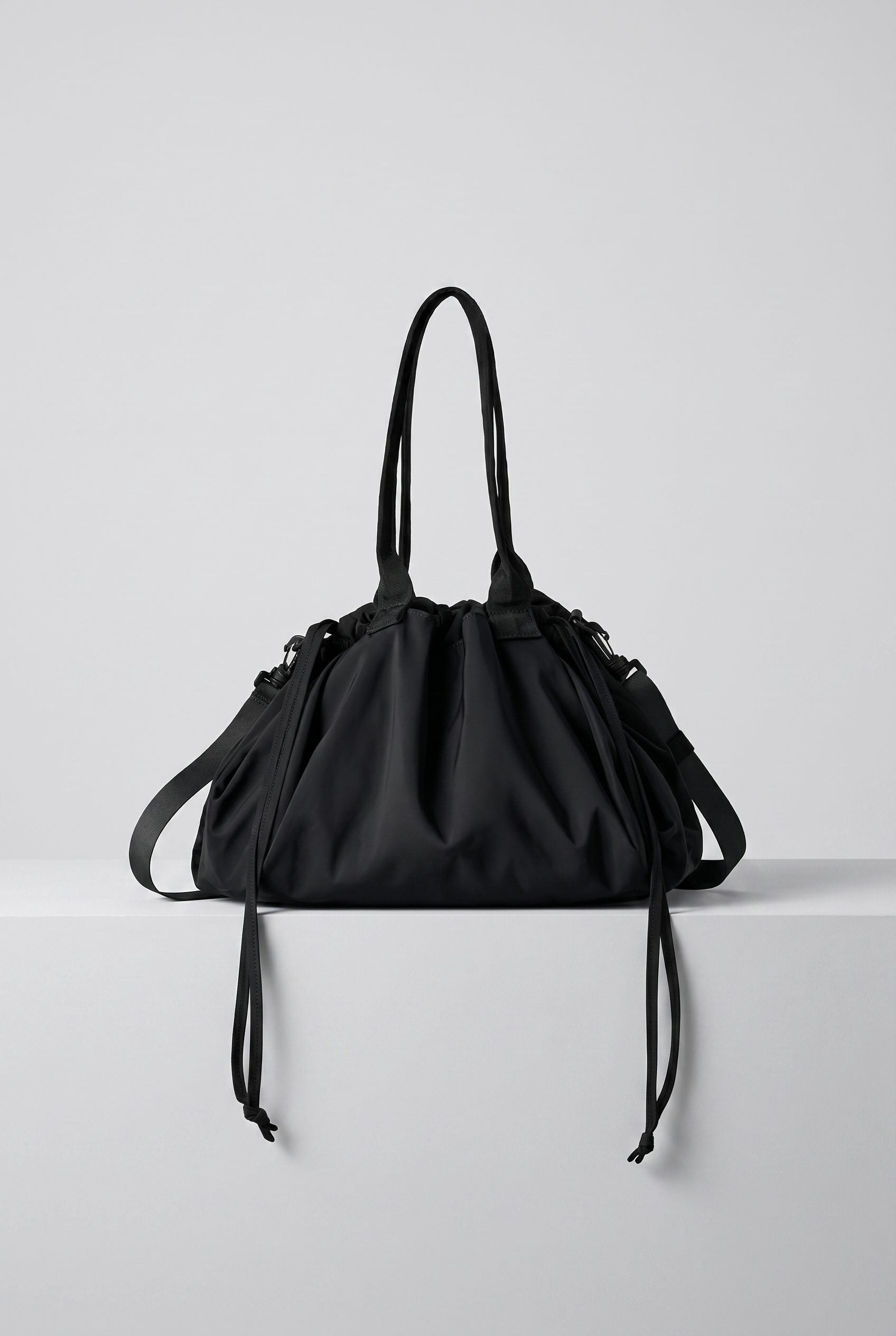 Amazon listing visual showing black drawstring bag studio for accessory, footwear, jewelry, and bag products