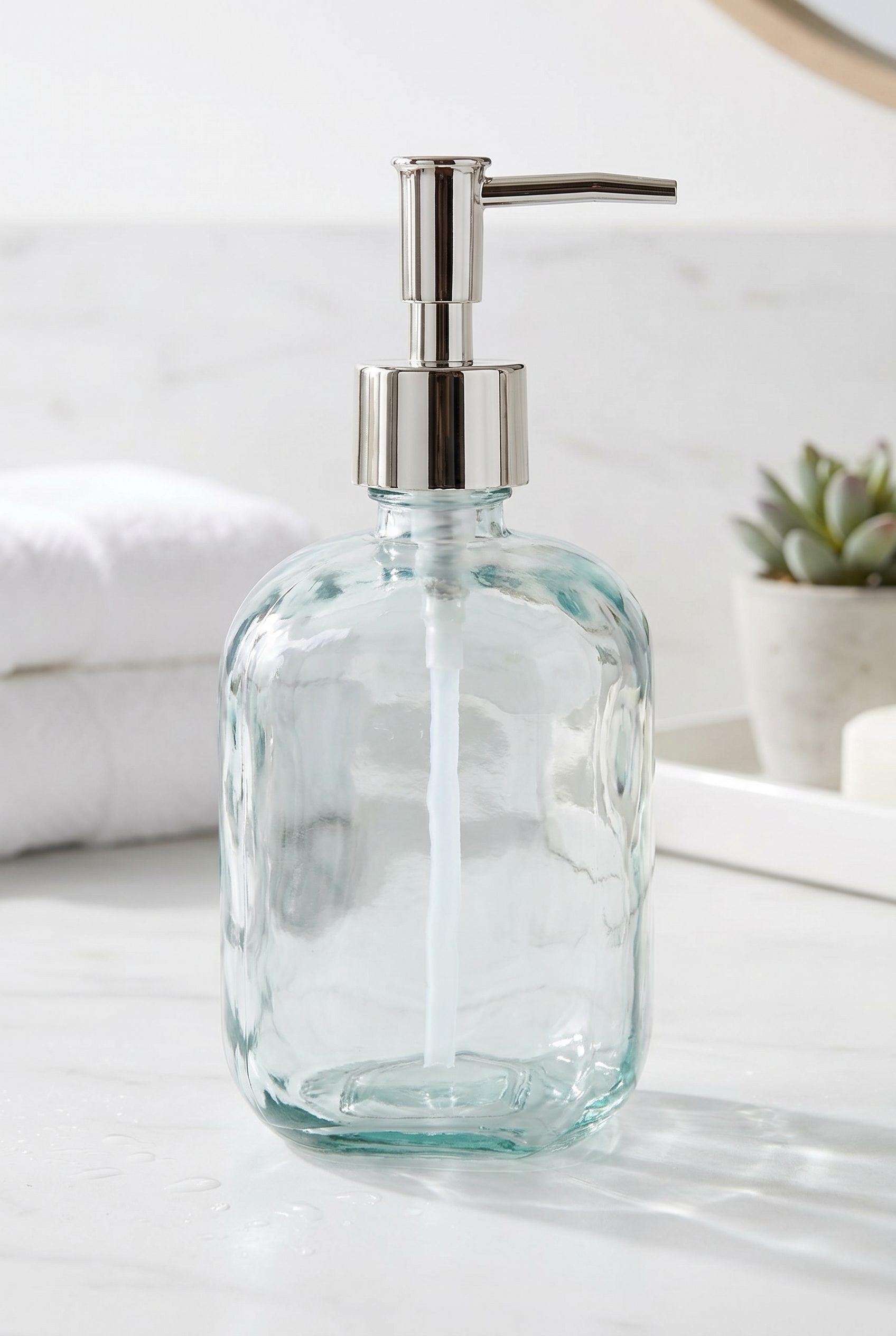 Fotogenic AI generated after image of a clear glass soap dispenser on a minimal bathroom vanity