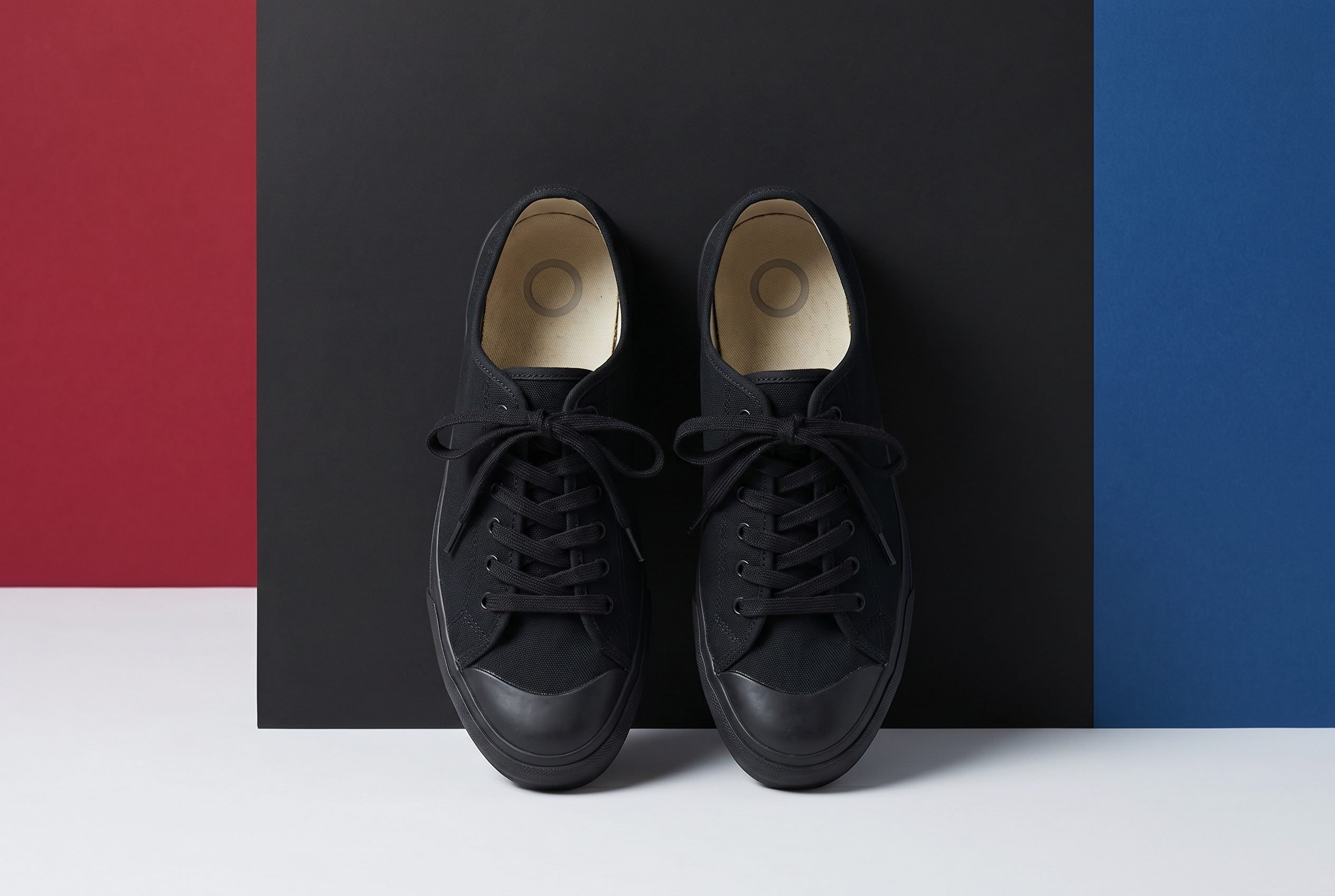 AI background generator output with sneakers in a color-block ecommerce ad scene