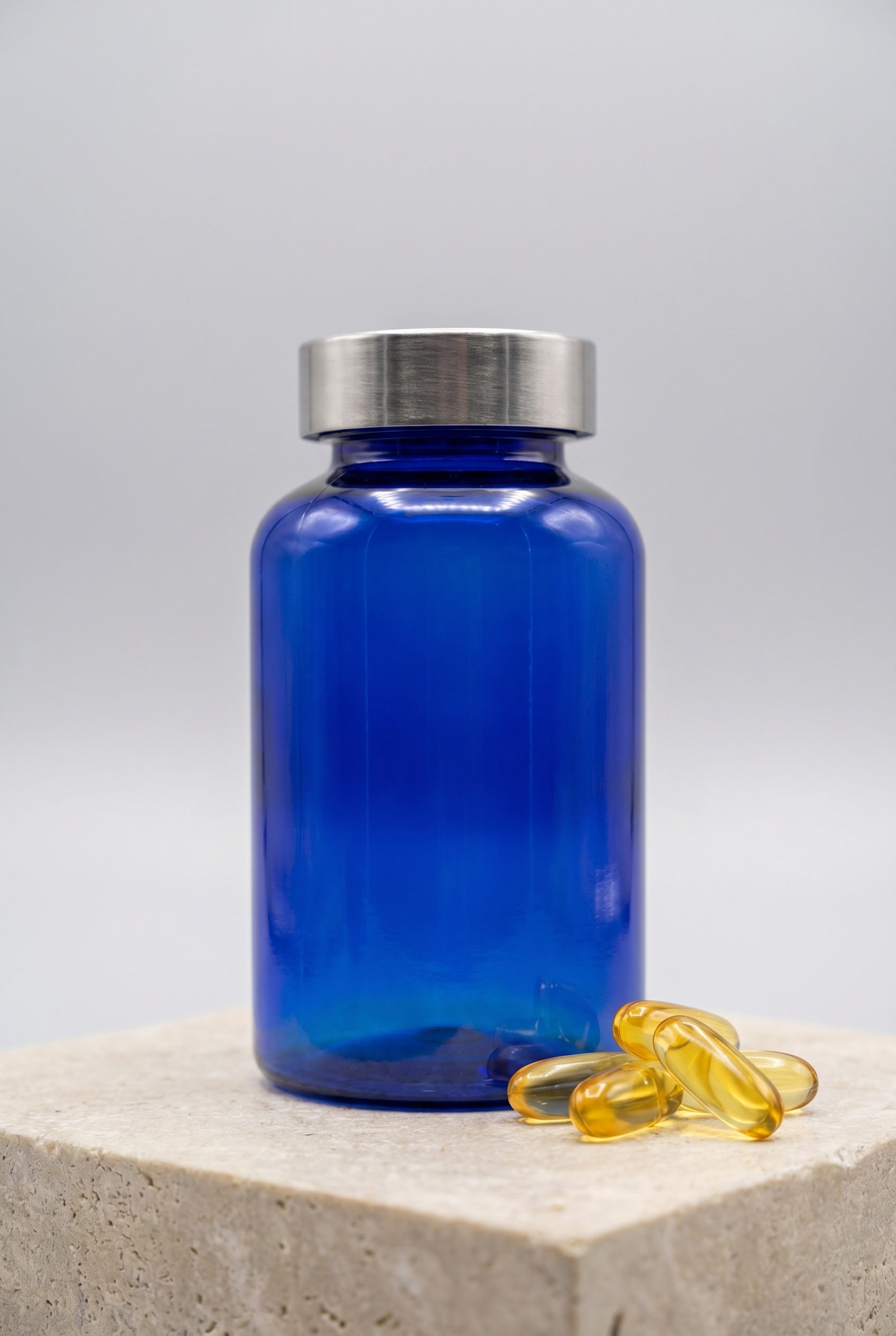 Supplement product photography blue bottle and capsules portrait