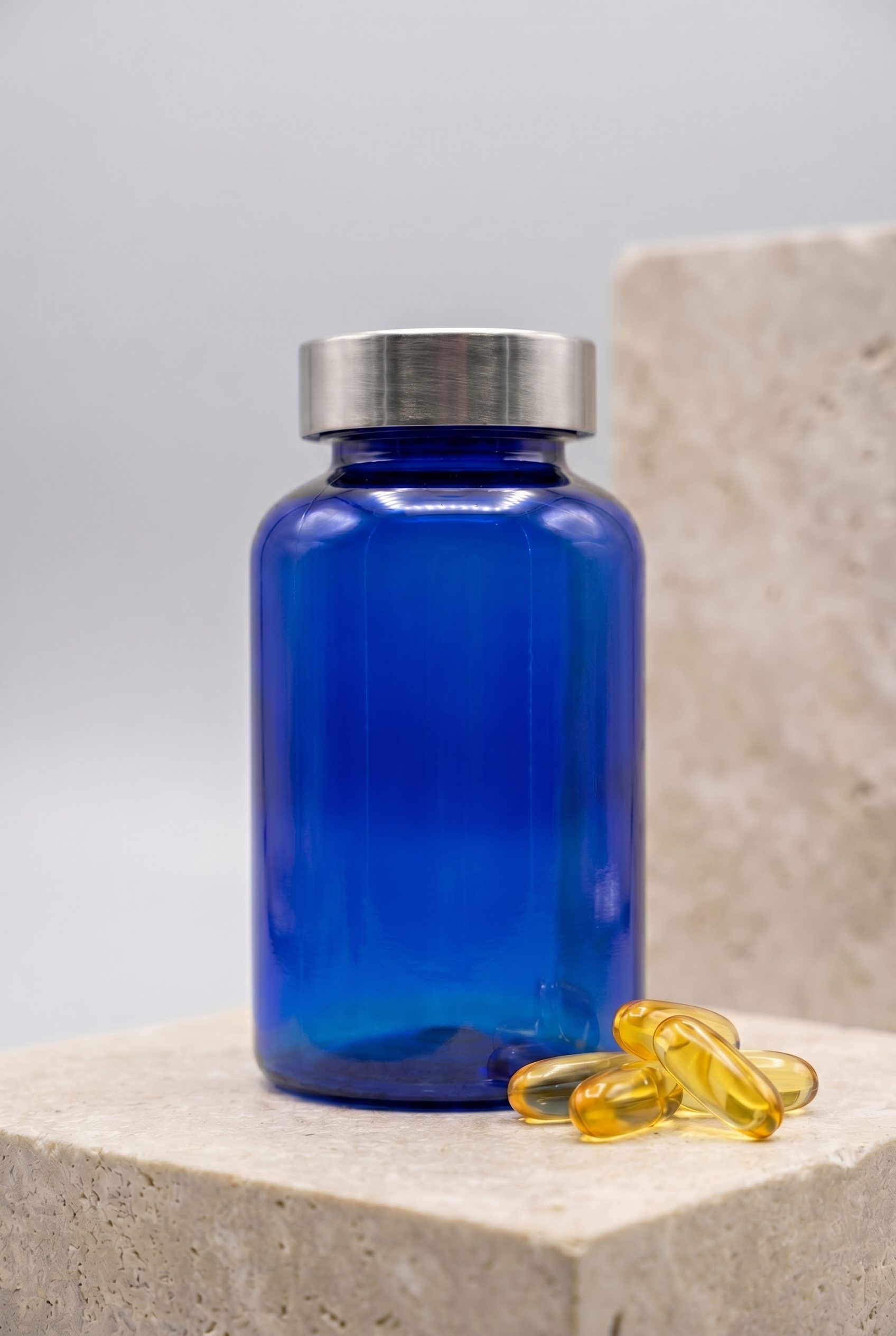 Supplement product photography portrait ecommerce image with logo-free bottles and capsules