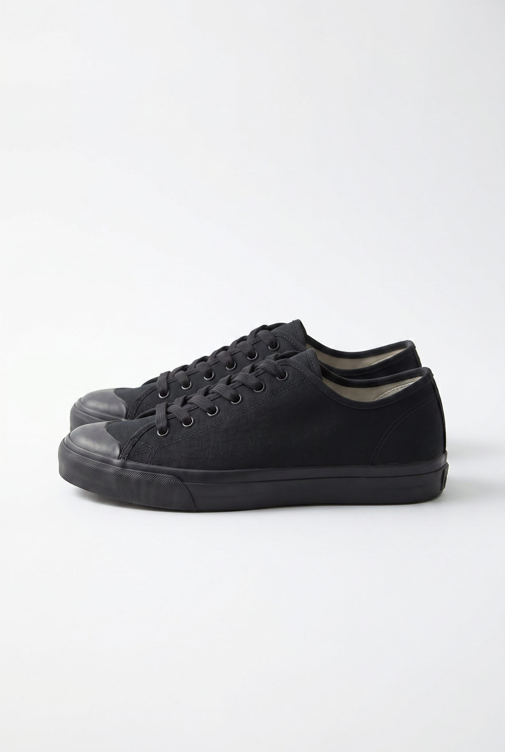 Black canvas sneakers for the footwear product photography agency studio tab