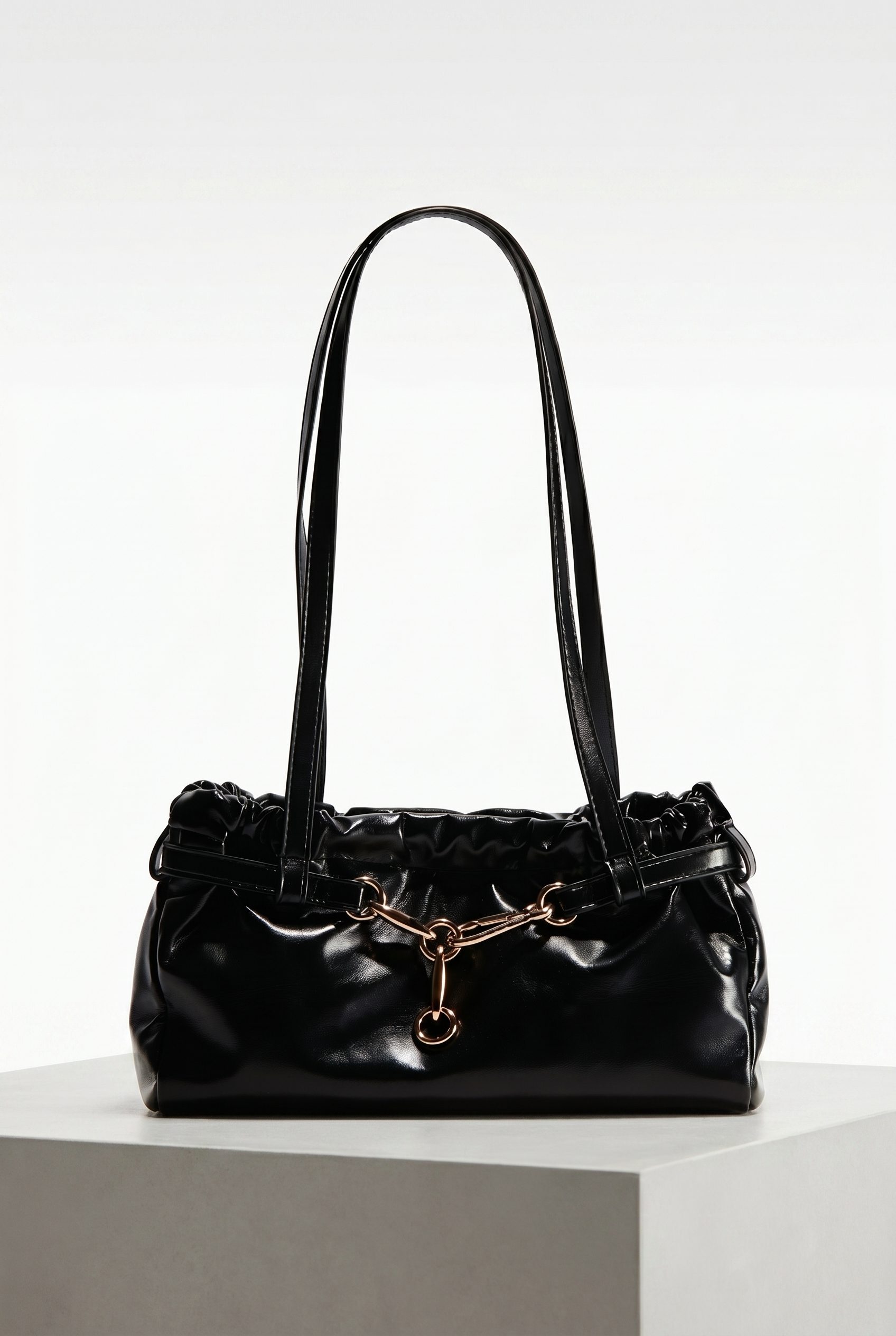 Bags product photography studio example of a black shoulder bag on a clean product pedestal
