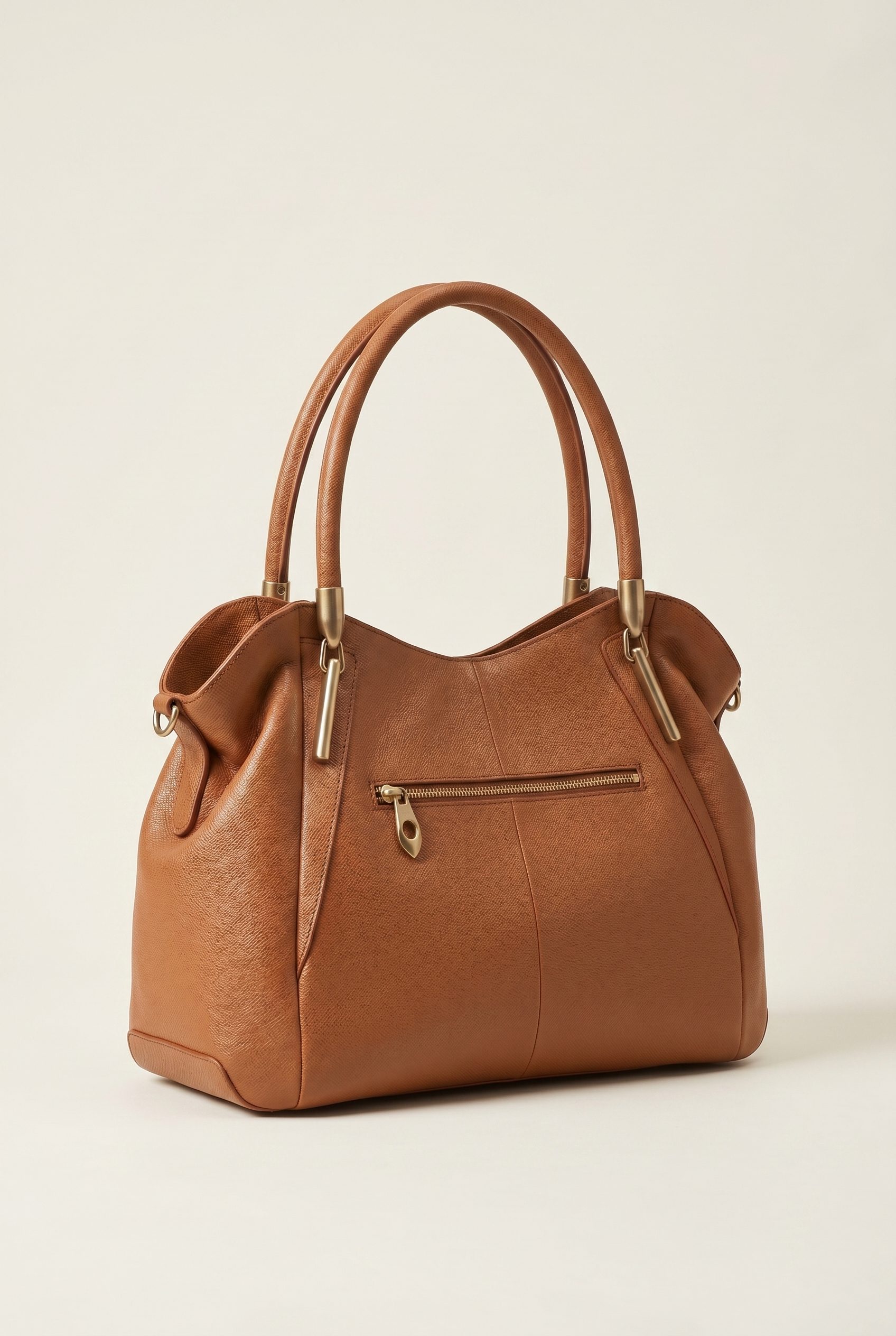 Bags product photography studio example of a tan leather satchel handbag on an ivory background