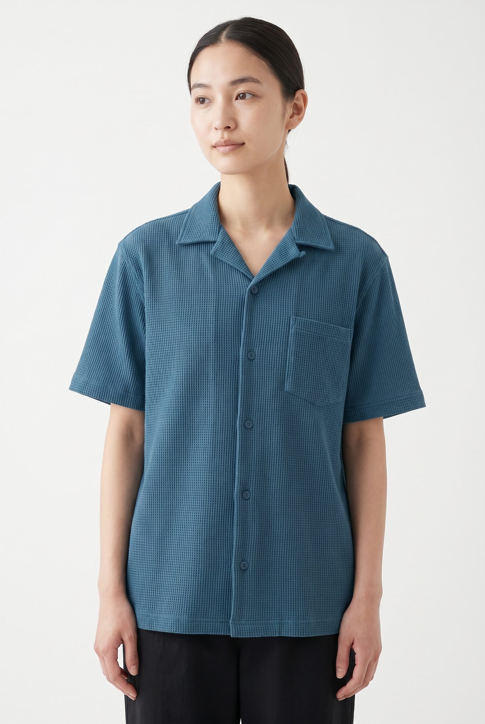 Fotogenic AI apparel product photography hero example showing a blue short sleeve shirt styled on an adult model.