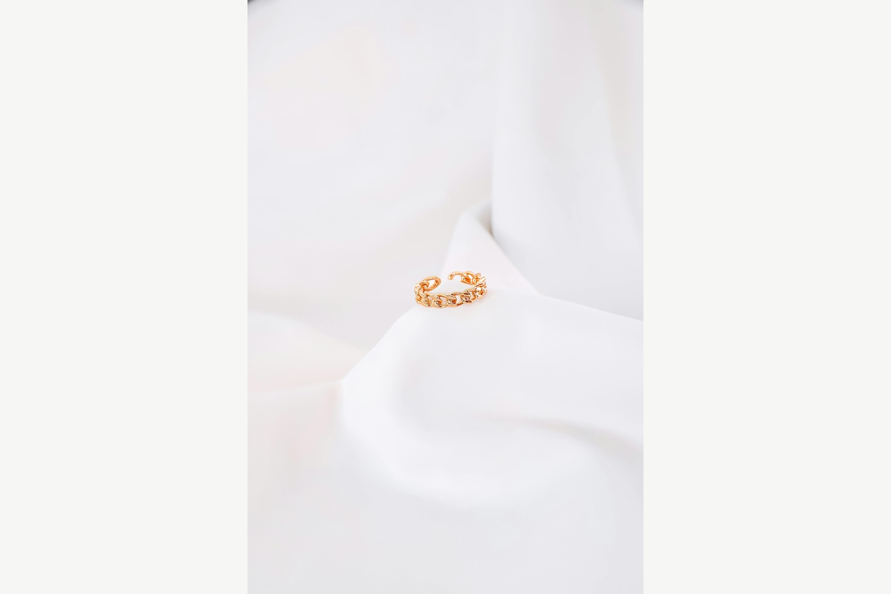 White Background Product Photos before image showing minimal gold ring on white fabric for jewelry packshot