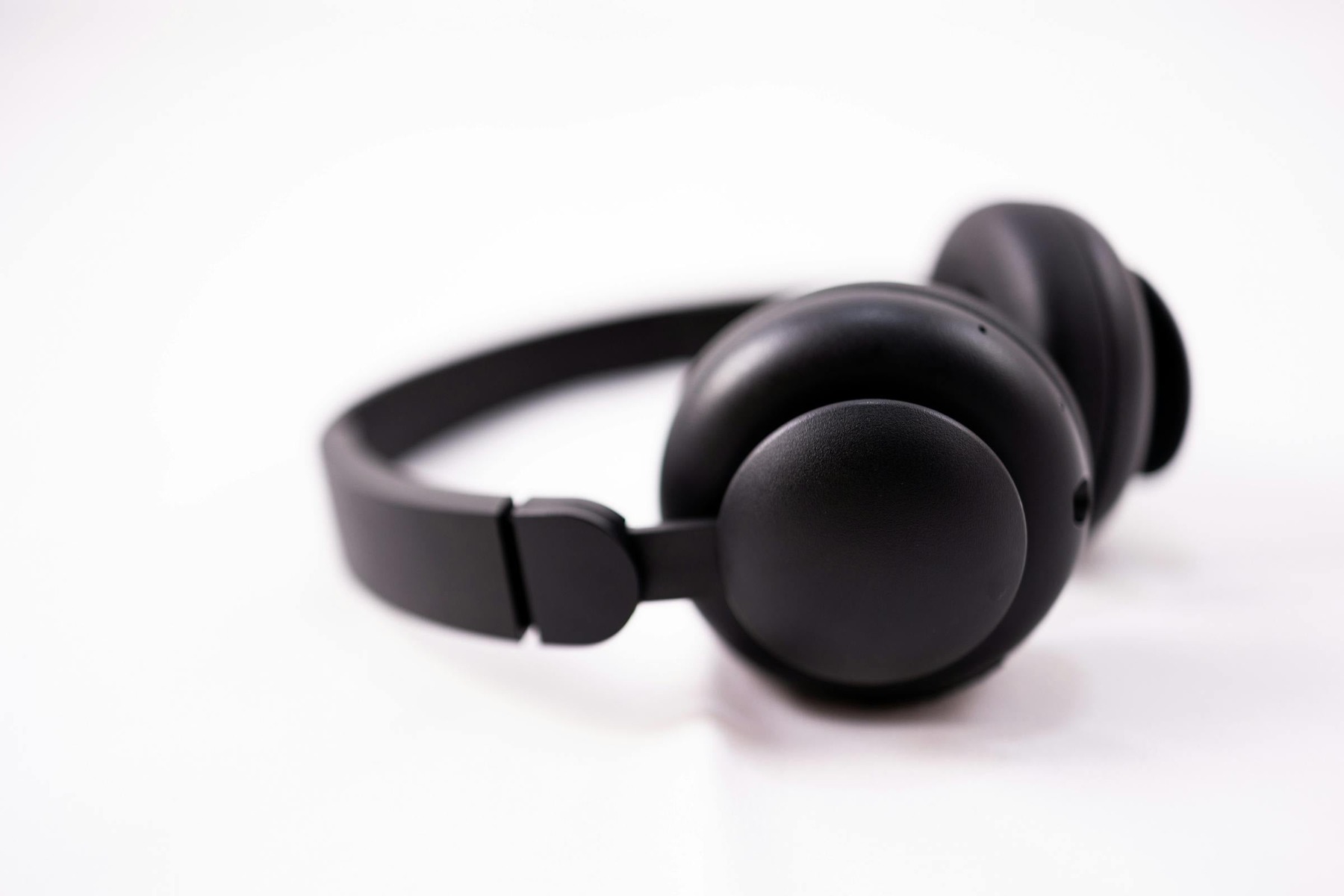 AI Product Photos for Ads before image showing black wireless headphones on white background for headphones promo