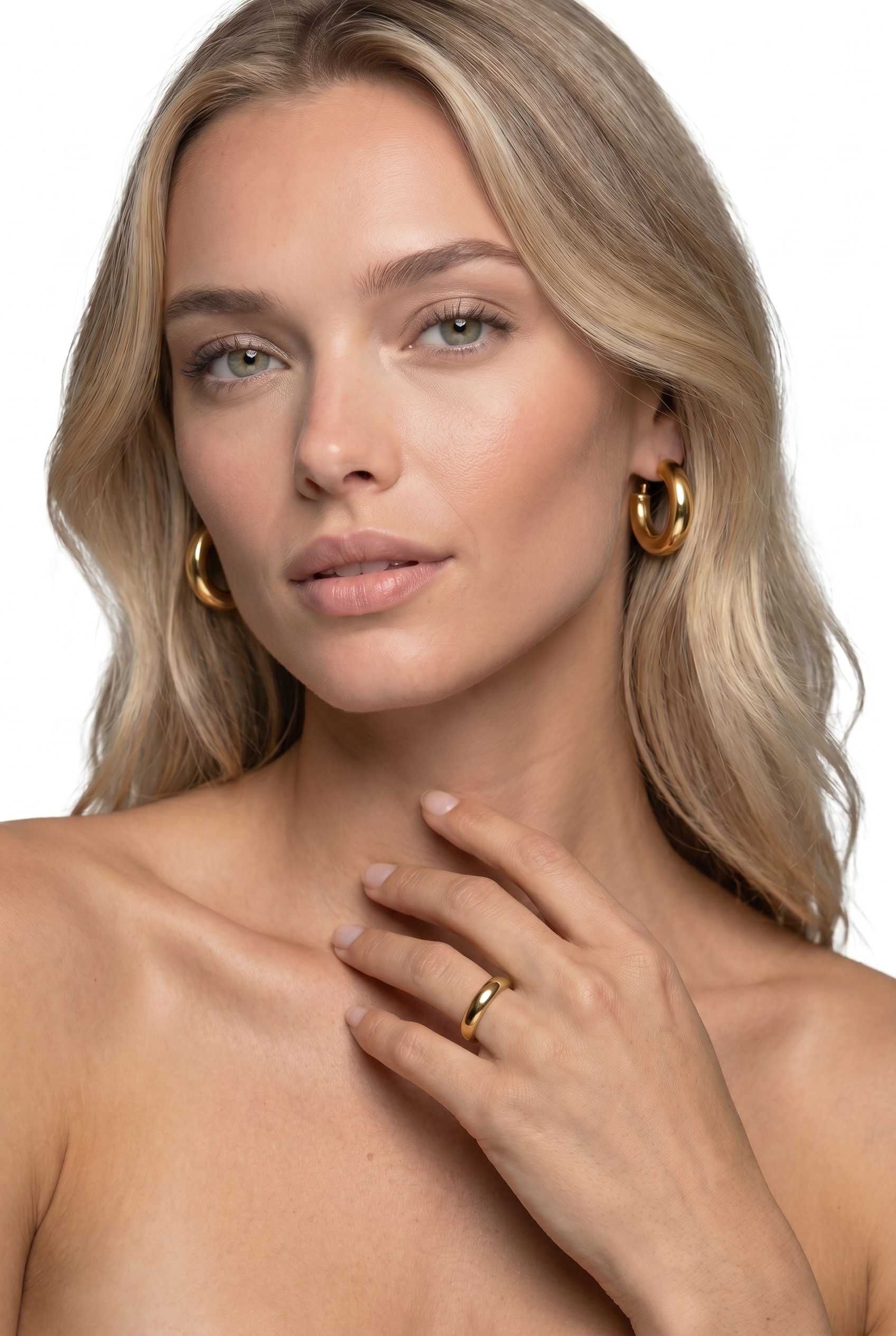 Model wearing gold jewelry with rings and earrings visible for ecommerce accessory photography.