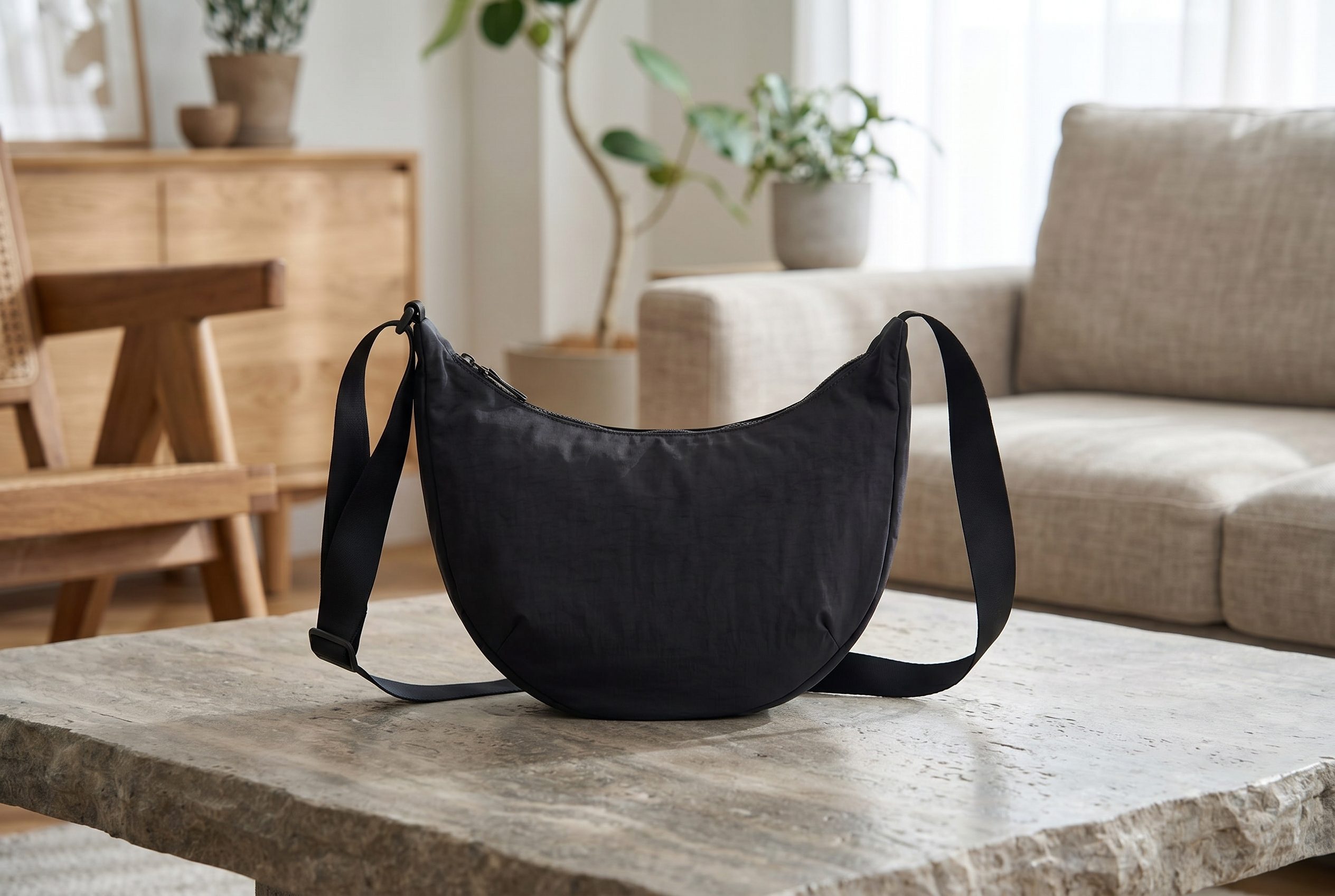 Bags product photography catalog card showing a black crossbody shoulder bag with its strap clearly arranged