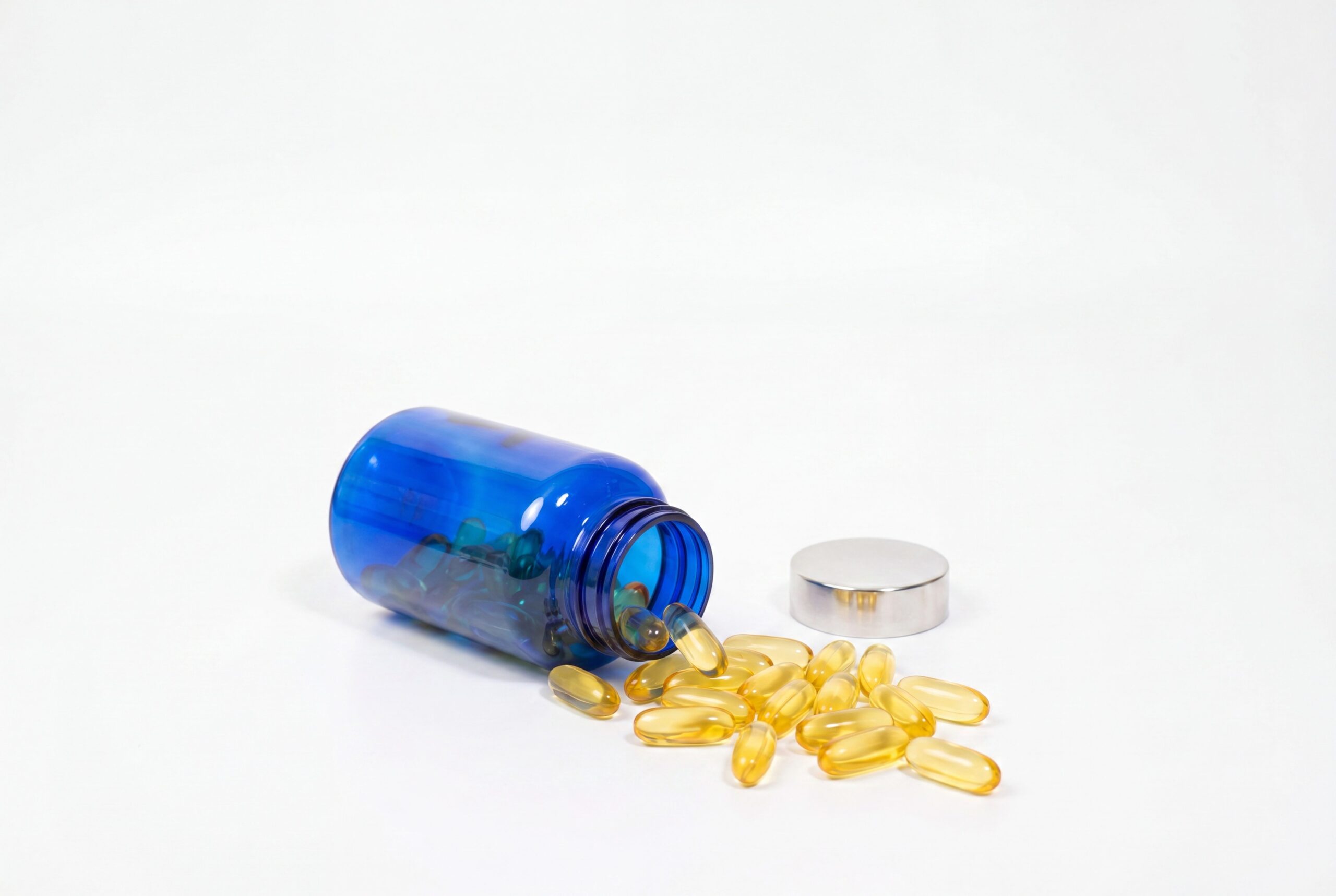 Supplement product photography audience image with a logo-free bottle and capsule flatlay