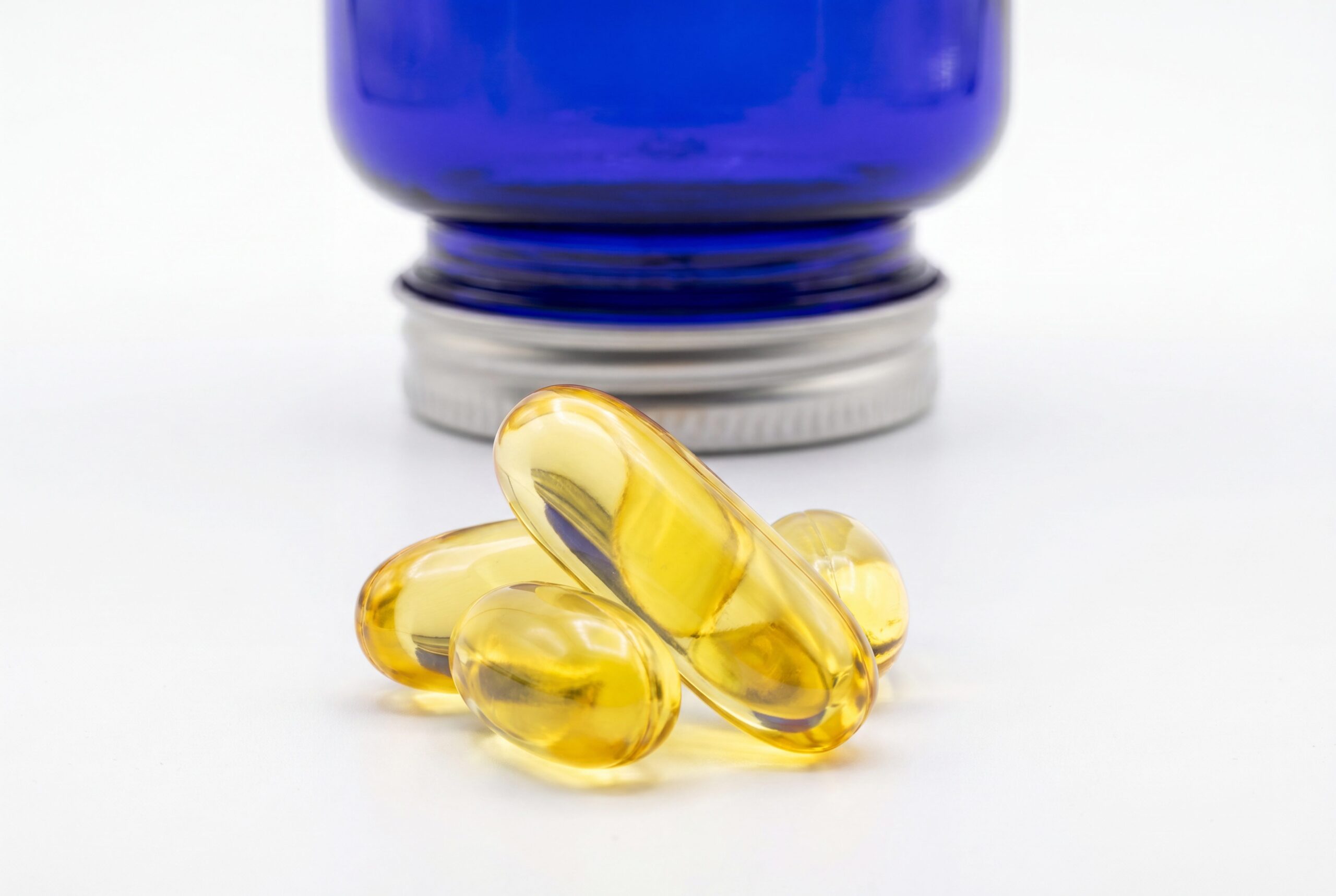 Supplement product photography audience image with logo-free softgel capsule details