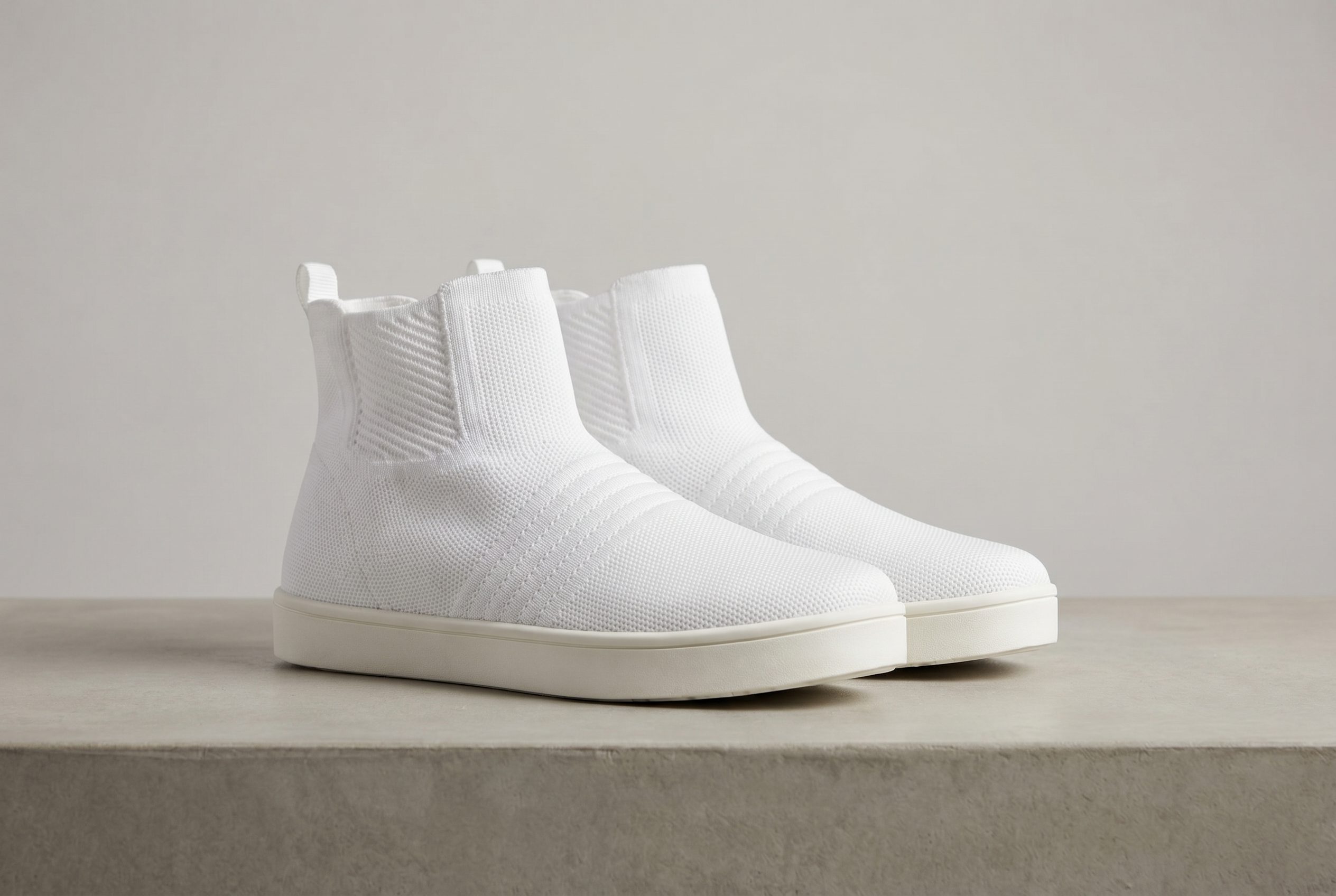 White knit sneakers photographed for ecommerce marketplace footwear images