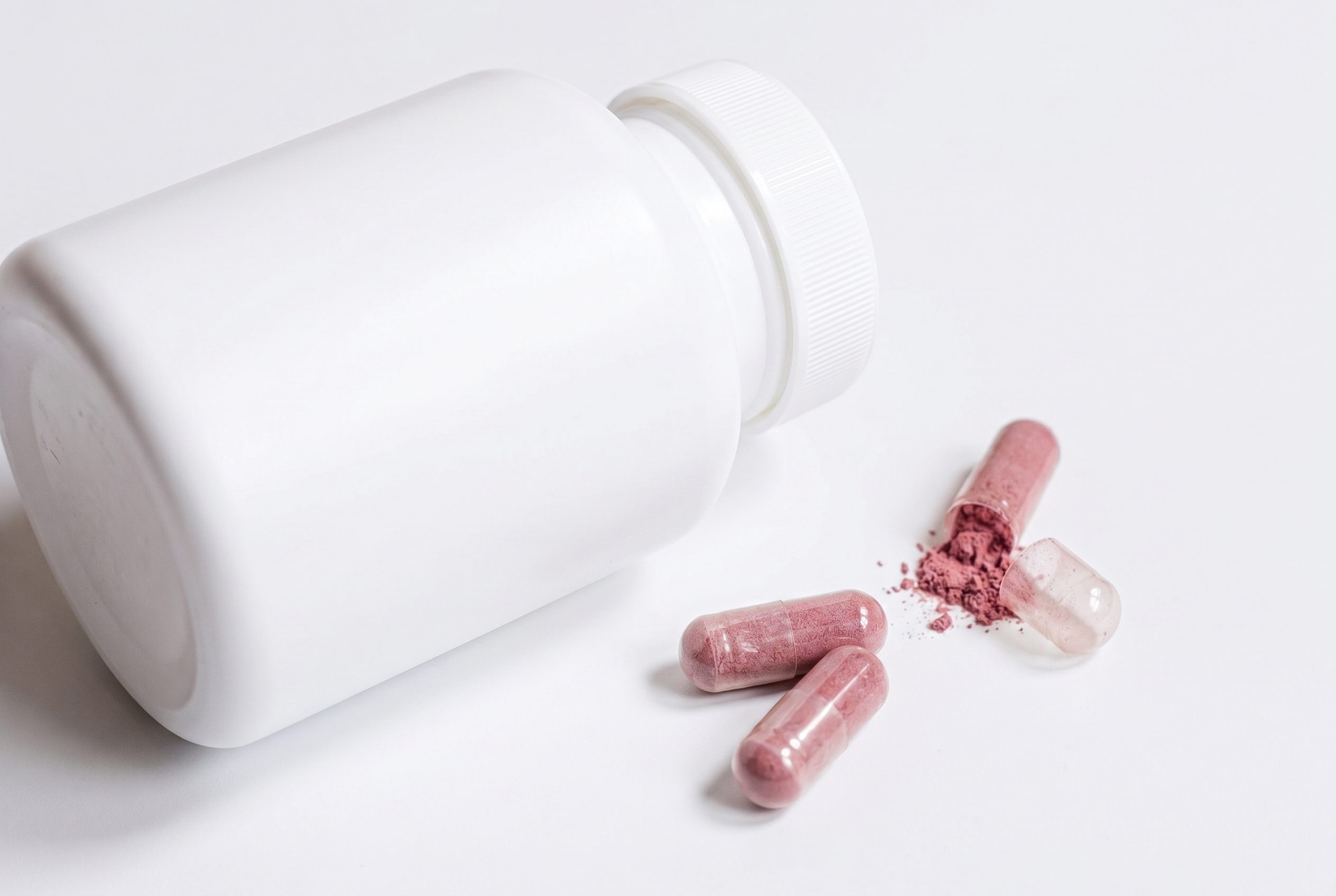 Plain supplement bottle with capsules and visible powder detail.