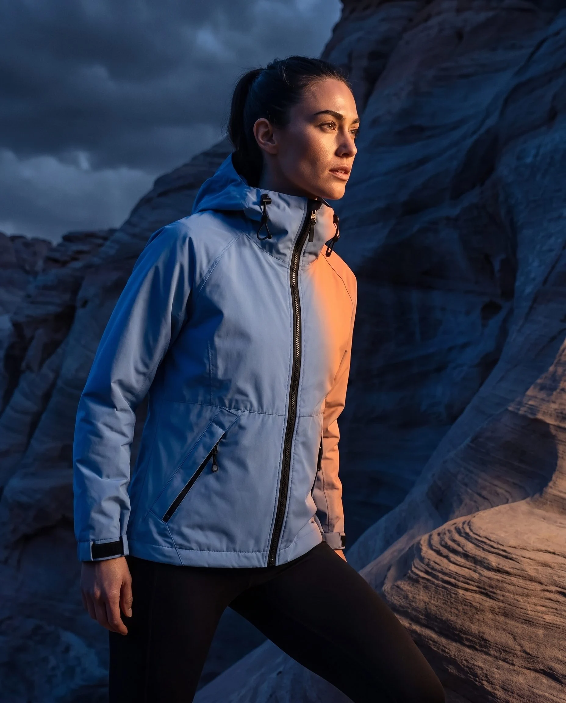 Blue rain jacket lit by blue and orange storm light