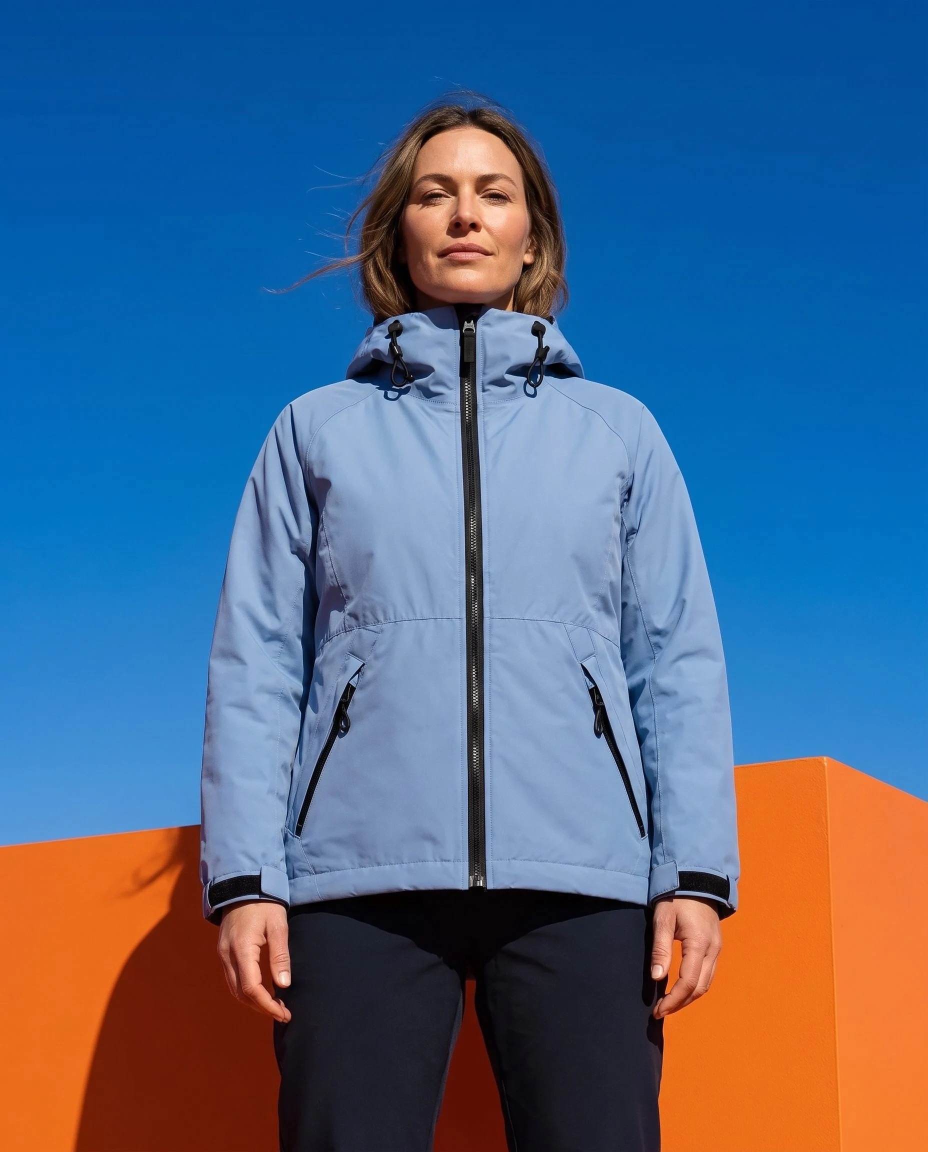 Blue jacket on a model against a cobalt and orange set