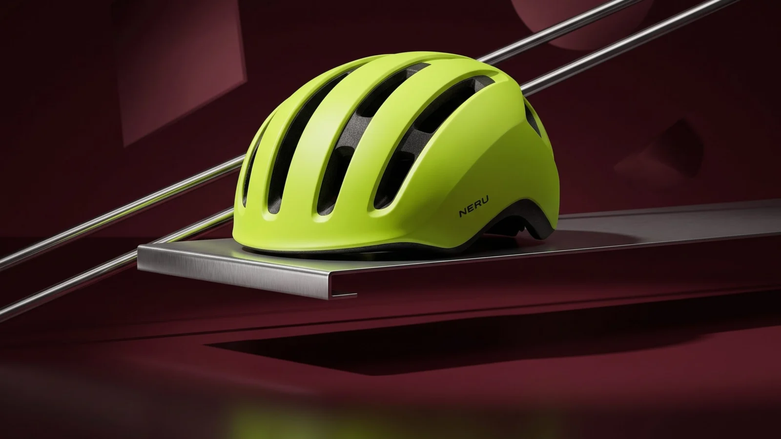 Lime NERU helmet on a chrome shelf against an oxblood setting.